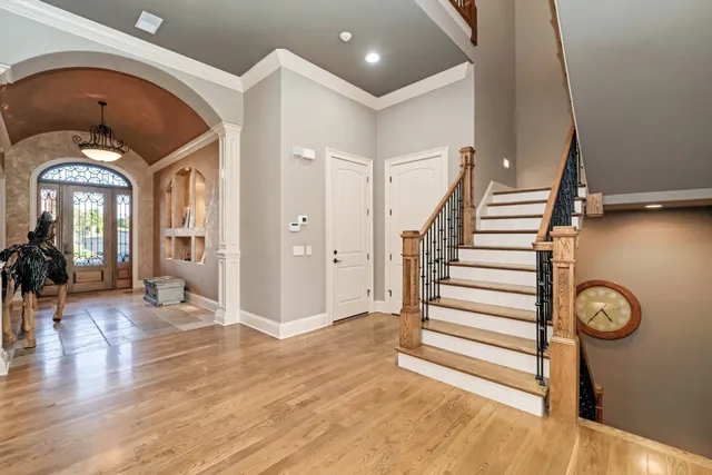 a dining hall with stainless steel appliances a dining table and chairs with wooden floor