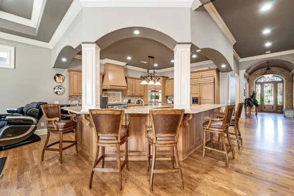 a kitchen with stainless steel appliances granite countertop a stove a sink and a microwave