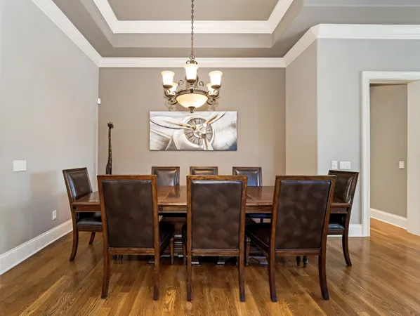 a spacious bedroom with a bed and a chandelier