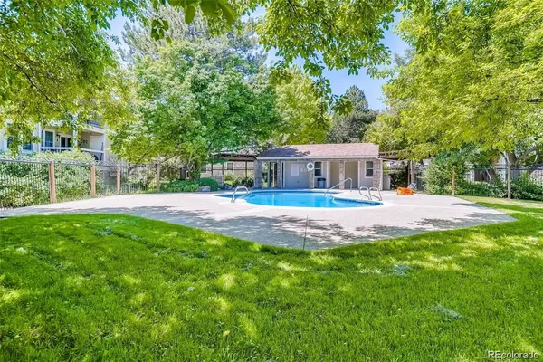 a view of house with swimming pool and yard