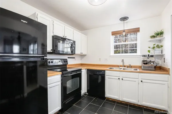 a kitchen with stainless steel appliances a stove sink and microwave