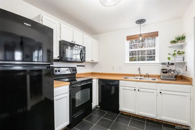 a kitchen with stainless steel appliances a stove sink and microwave
