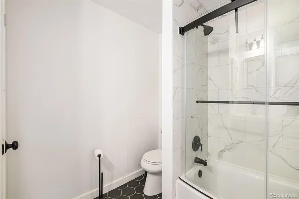 a bathroom with a shower and a toilet