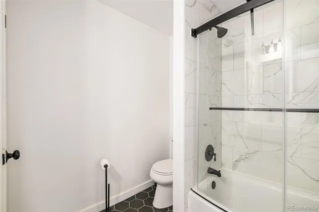 a bathroom with a shower and a toilet