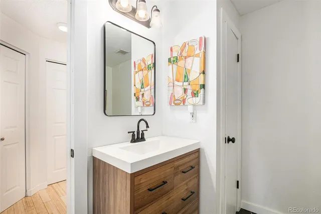 a bathroom with 2 sink and a mirror