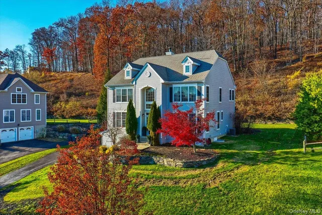 a view of a house with a big yard and potted plants
