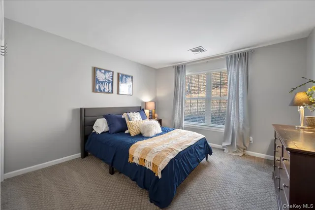 a bedroom with a bed and a television