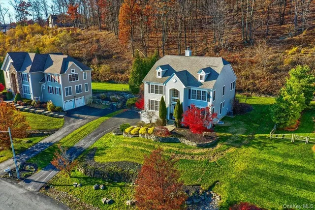a view of a house with swimming pool and yard