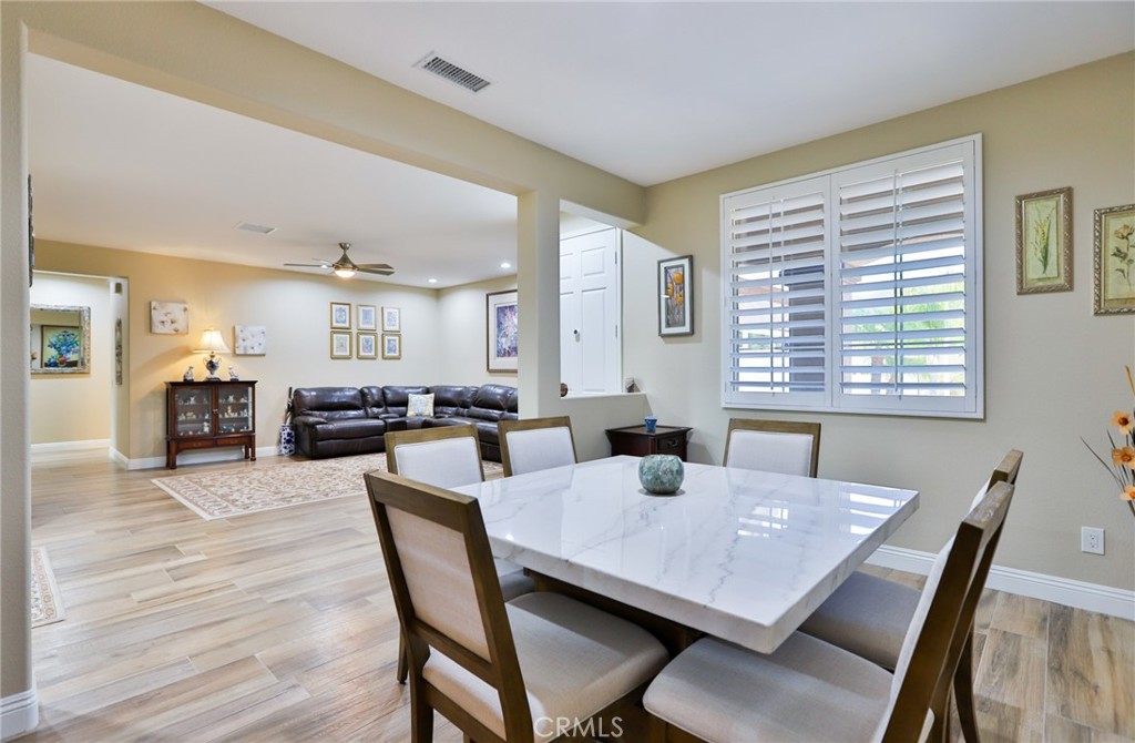 1789 Kapalua Bay Lane Corona, CA 92883 - Photo 14 of 63 a view of a dining room with furniture and wooden floor