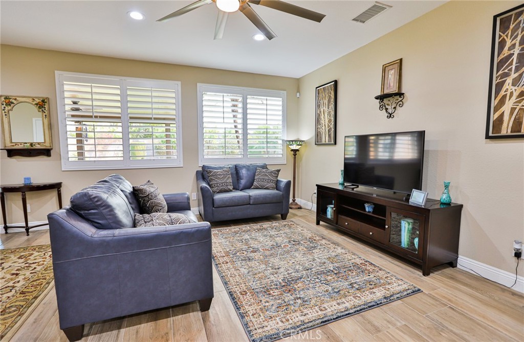 1789 Kapalua Bay Lane Corona, CA 92883 - Photo 15 of 63 a living room with furniture and a flat screen tv