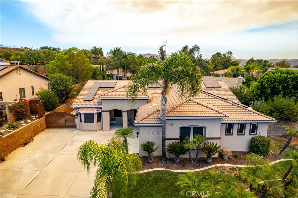 1789 Kapalua Bay Lane Corona, CA 92883 - Photo 2 of 63 a aerial view of a house with table and chairs under an umbrella