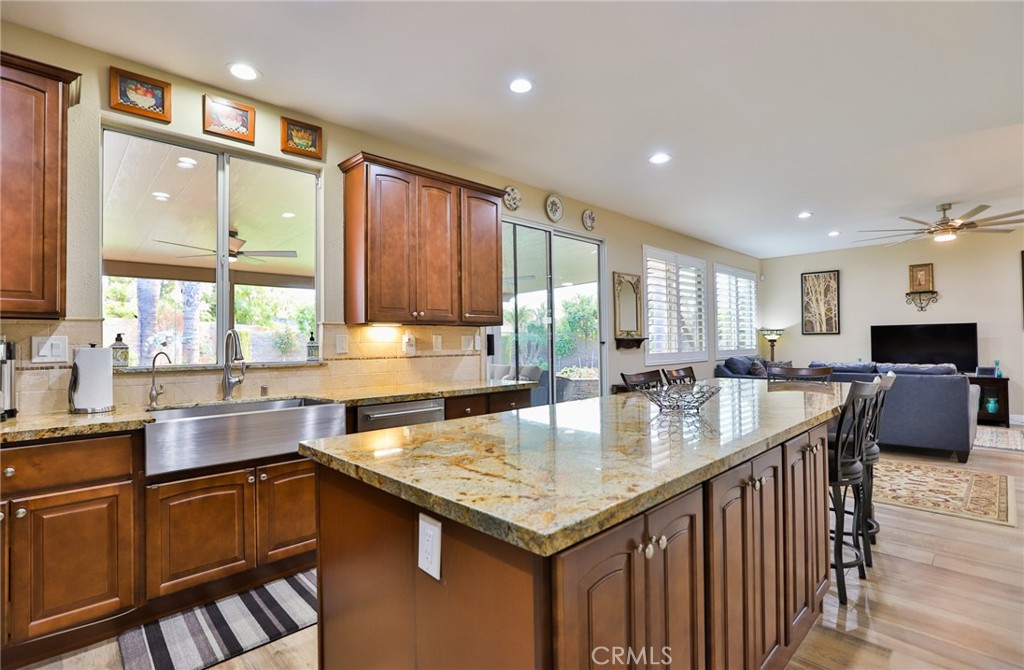 1789 Kapalua Bay Lane Corona, CA 92883 - Photo 23 of 63 a kitchen with stainless steel appliances granite countertop a sink a stove and a refrigerator