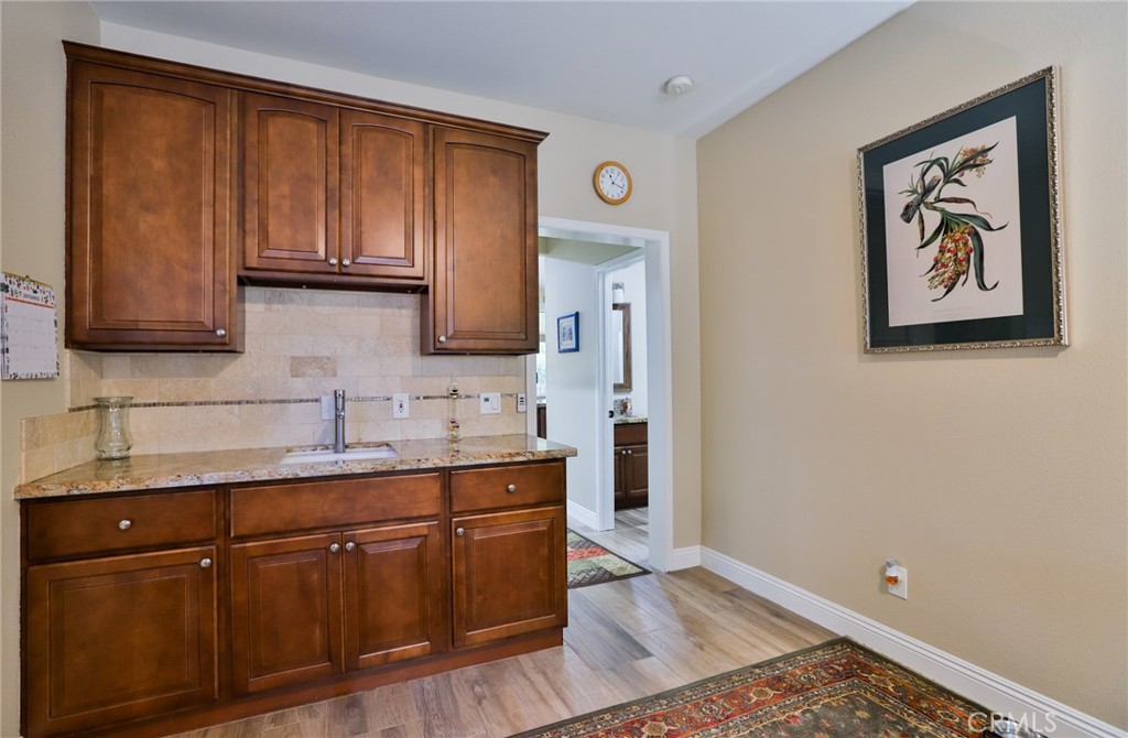 1789 Kapalua Bay Lane Corona, CA 92883 - Photo 27 of 63 a kitchen with a sink cabinets and wooden floor