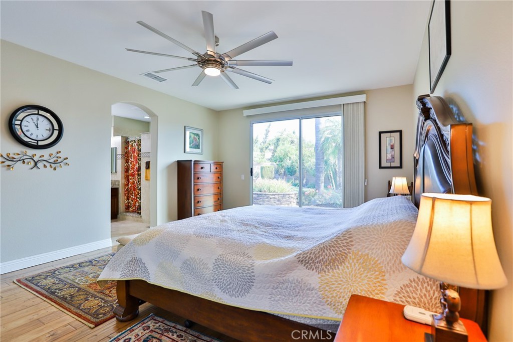 1789 Kapalua Bay Lane Corona, CA 92883 - Photo 30 of 63 a bedroom with a bed and a chandelier