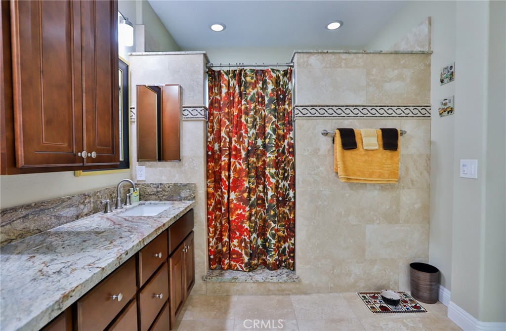 1789 Kapalua Bay Lane Corona, CA 92883 - Photo 33 of 63 a bathroom with a granite countertop sink and a mirror