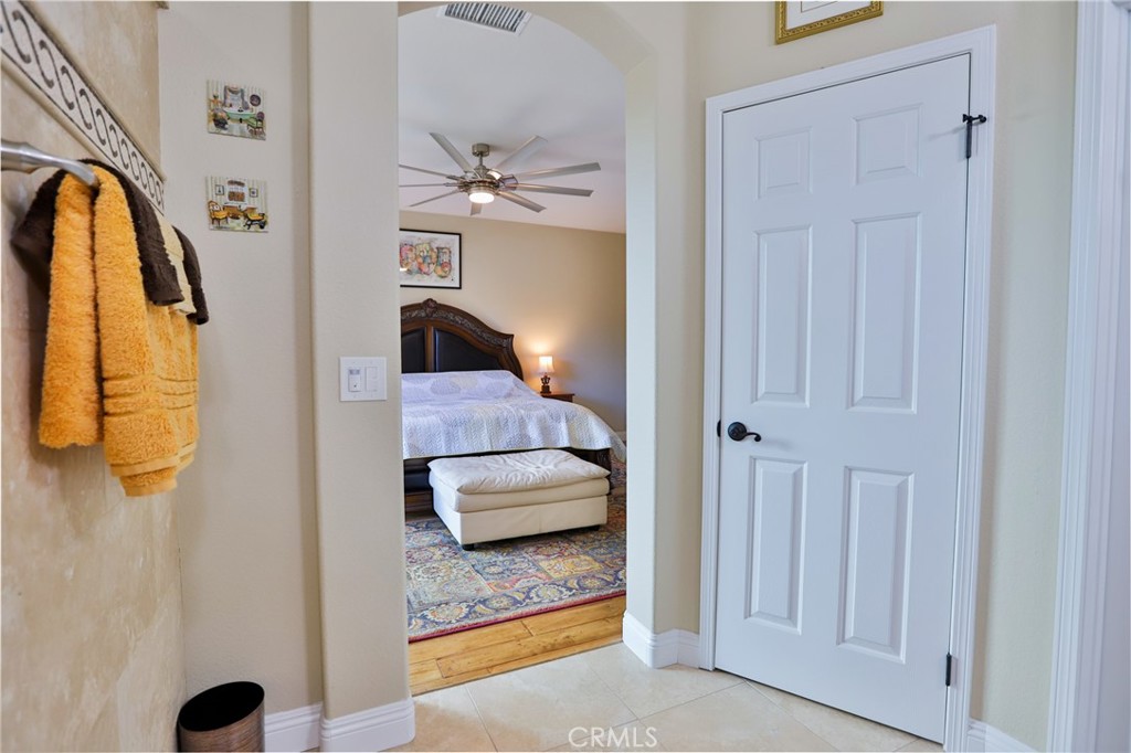 1789 Kapalua Bay Lane Corona, CA 92883 - Photo 34 of 63 a bedroom with a bed and a chandelier