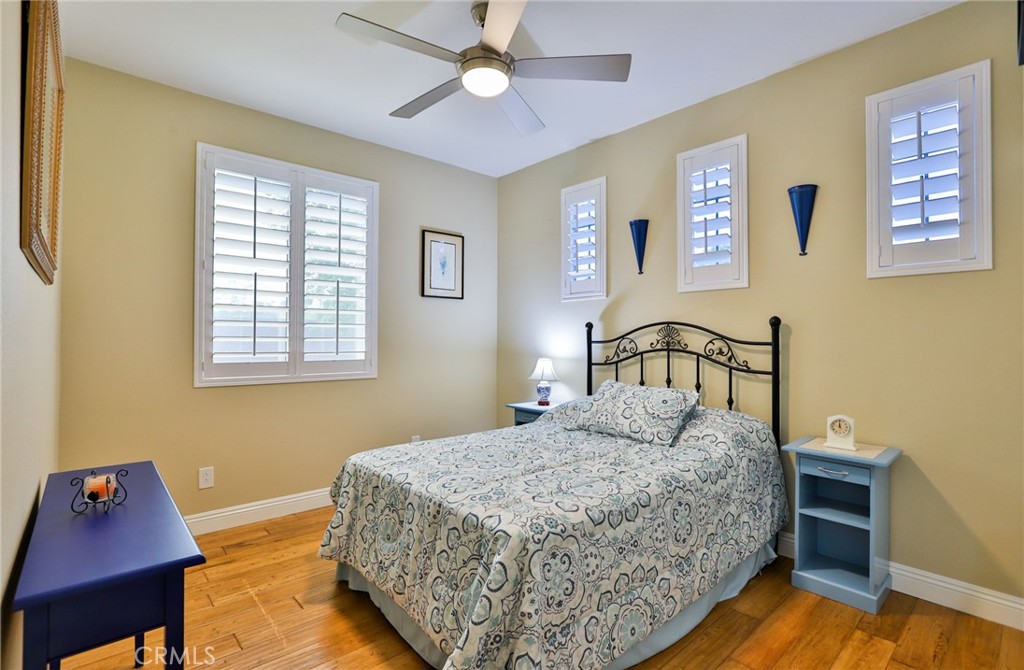 1789 Kapalua Bay Lane Corona, CA 92883 - Photo 36 of 63 a bedroom with a bed and wooden floor