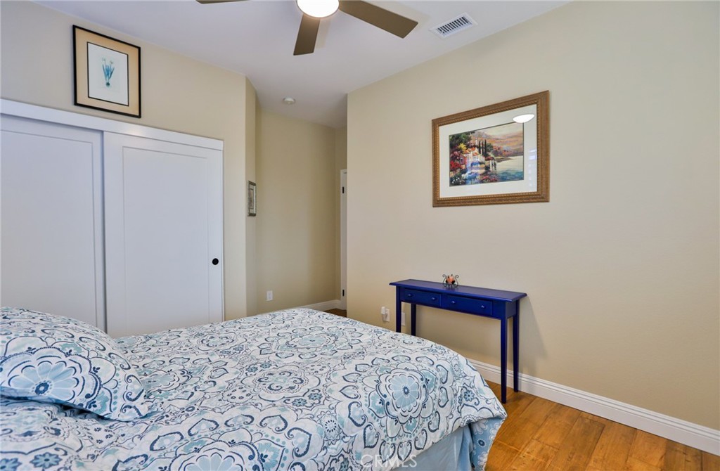1789 Kapalua Bay Lane Corona, CA 92883 - Photo 37 of 63 a bedroom with bed and painting on the wall