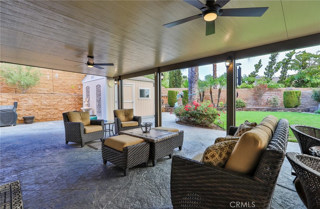 1789 Kapalua Bay Lane Corona, CA 92883 - Photo 46 of 63 a living room with patio furniture and a floor to ceiling window
