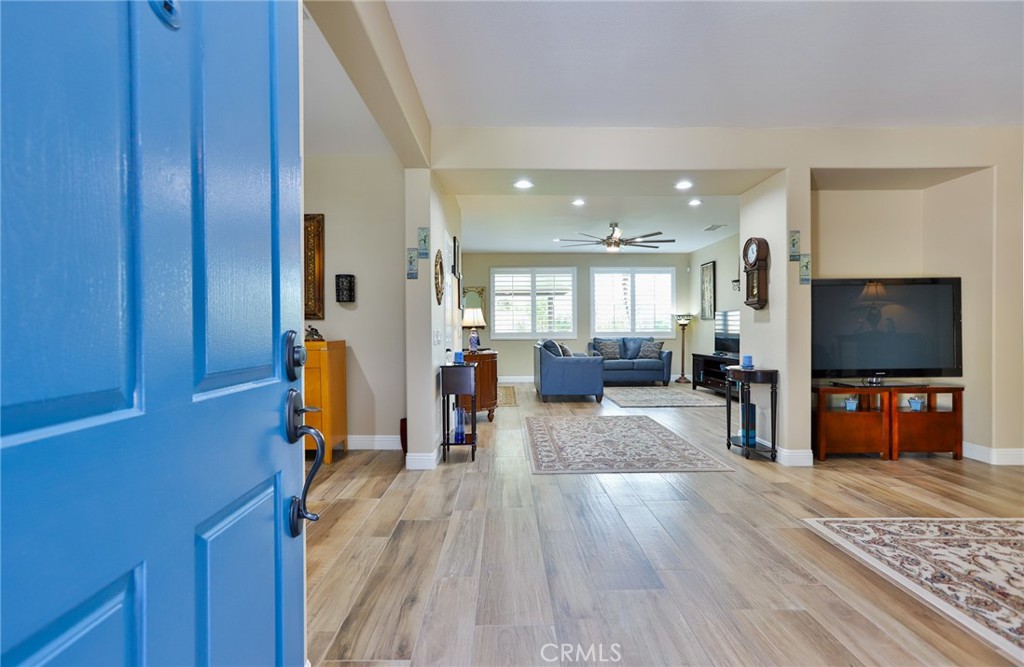 1789 Kapalua Bay Lane Corona, CA 92883 - Photo 6 of 63 a living room with furniture and a flat screen tv