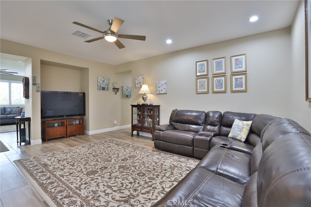 1789 Kapalua Bay Lane Corona, CA 92883 - Photo 8 of 63 a living room with furniture and a flat screen tv