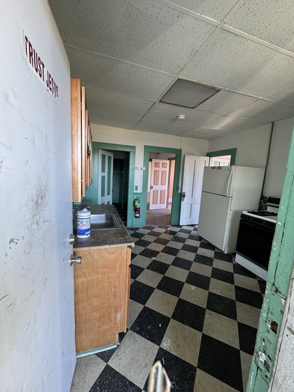 435-455 State Street Springfield, MA 01105 - Photo 8 of 13 a living room with a black white checkered floor with a gaming machine and checkered floor