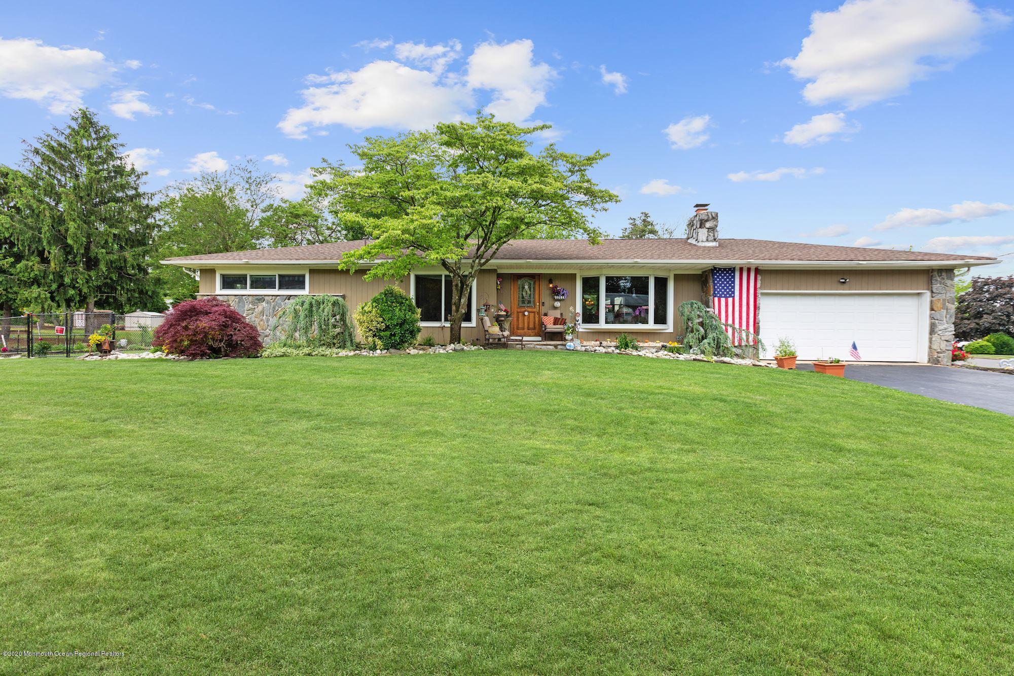 a front view of house with yard and green space