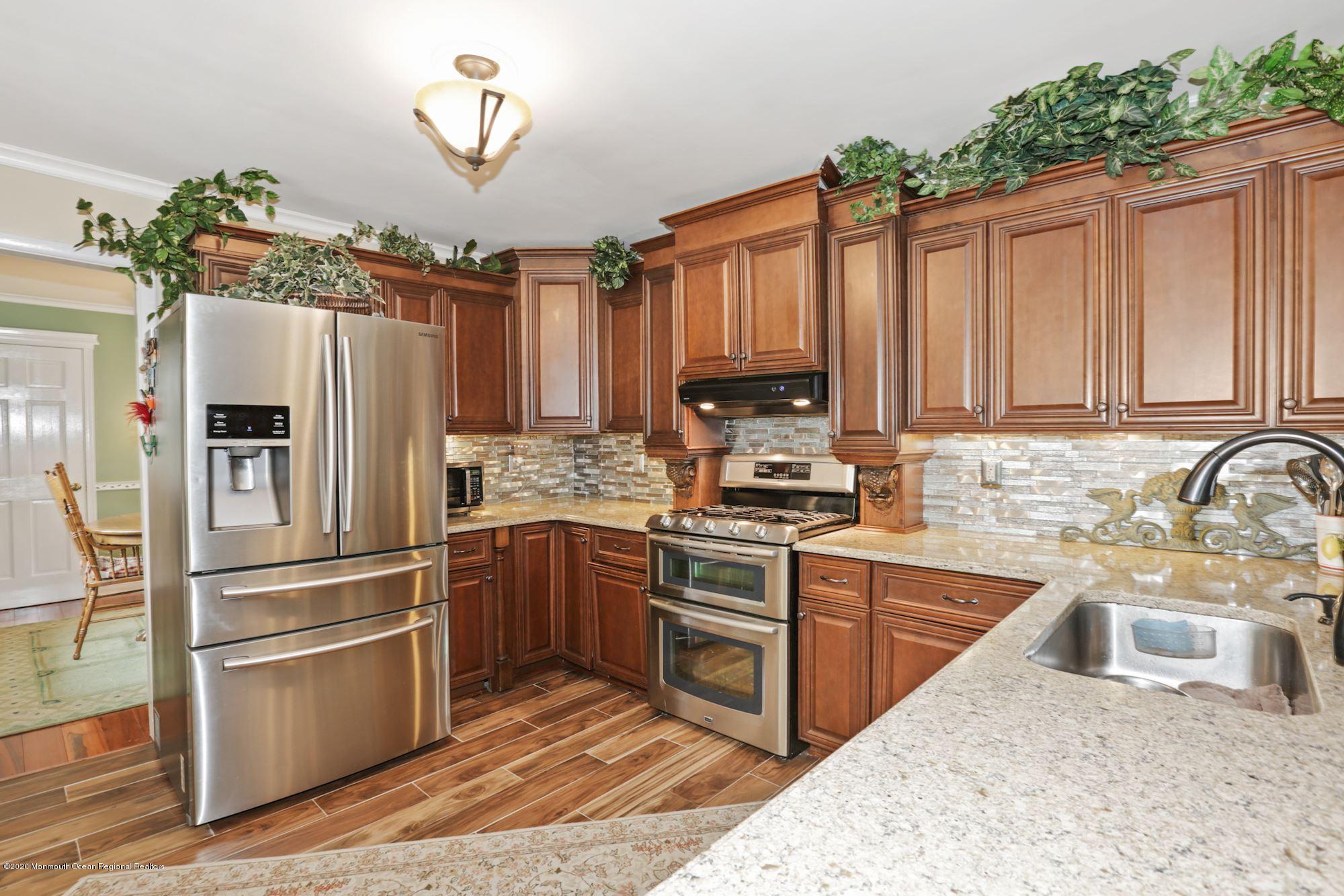 429 Crestview Terrace Brick, NJ 08723 - Photo 15 of 29 a kitchen with stainless steel appliances granite countertop a refrigerator sink and cabinets