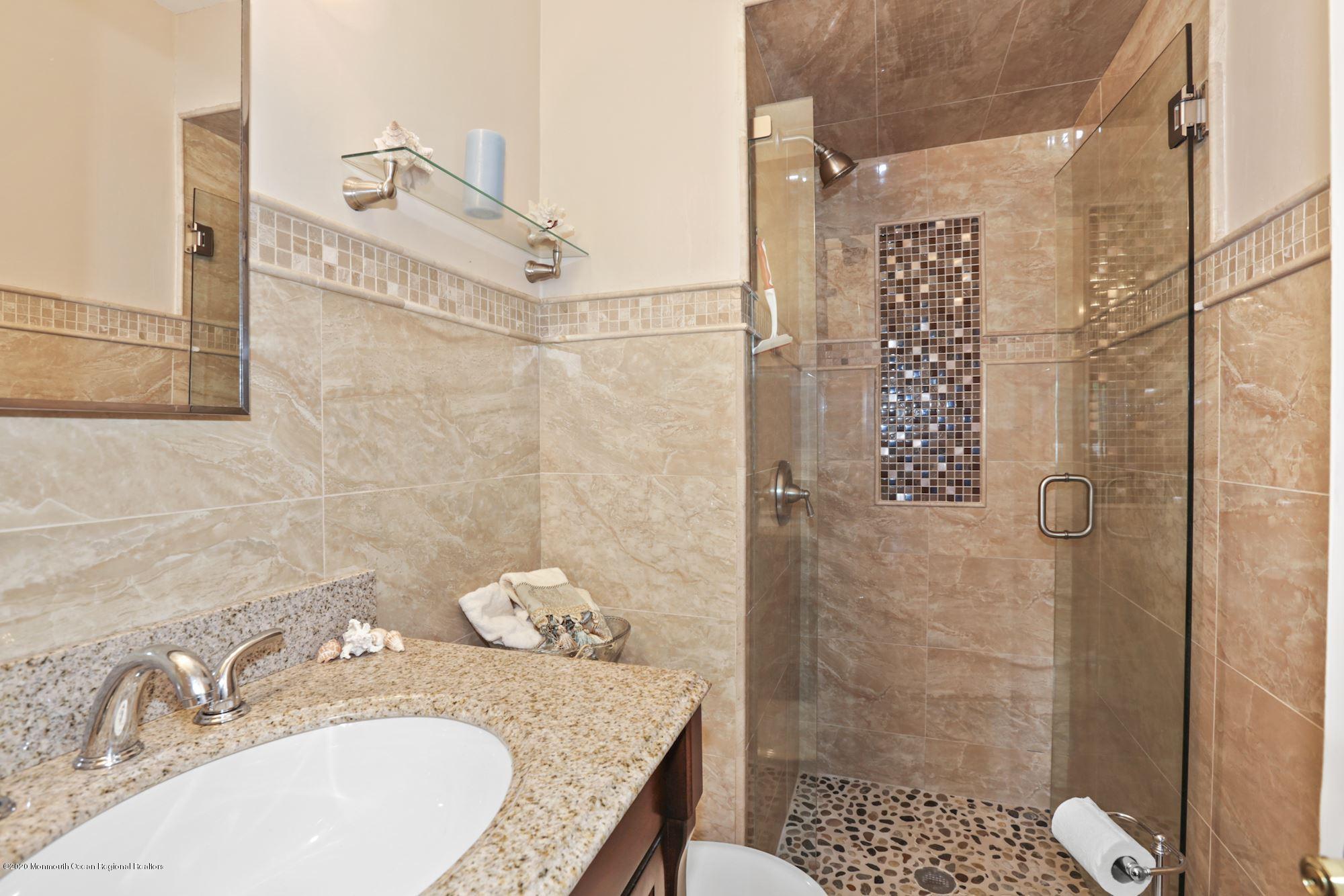 429 Crestview Terrace Brick, NJ 08723 - Photo 25 of 29 a bathroom with a granite countertop shower a sink and toilet