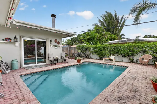 a view of a swimming pool with furniture