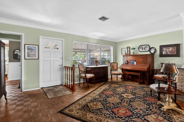a living room with furniture a rug and a flat screen tv