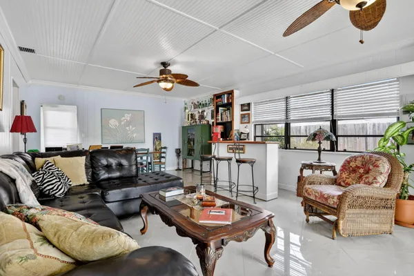 a living room with furniture a rug and a window