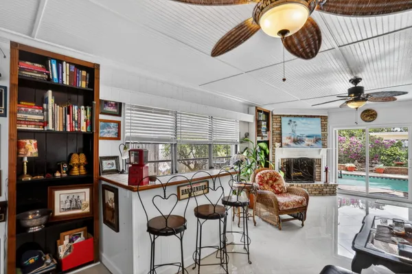 a living room with furniture a fireplace and a book shelf