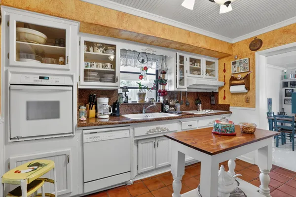 a kitchen with a sink stove and cabinets