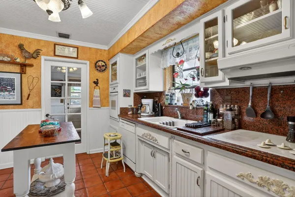 a kitchen with stainless steel appliances granite countertop a stove and cabinets