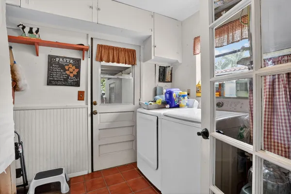 a kitchen with a refrigerator and cabinets