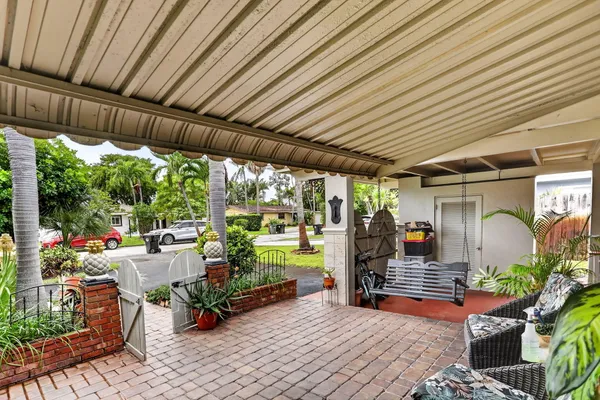 a sitting area with furniture and wooden fence