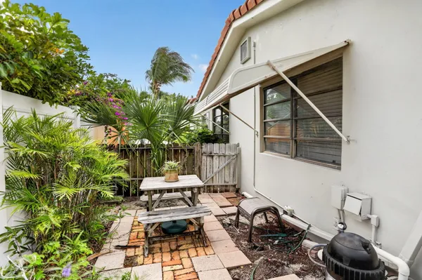 a view of backyard of house with seating space