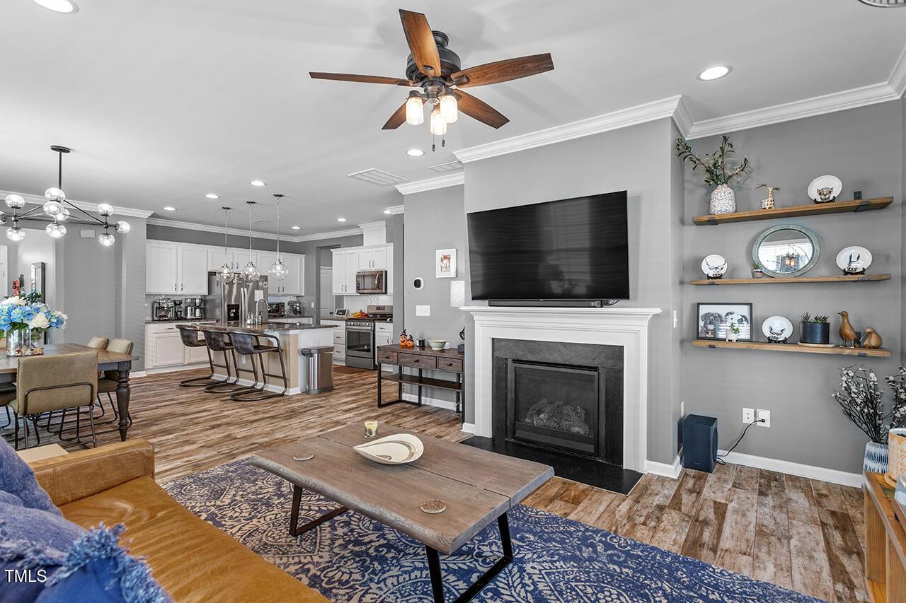 1420 Southpoint Trail Durham, NC 27713 - Photo 14 of 33 a living room with furniture a fireplace and a flat screen tv