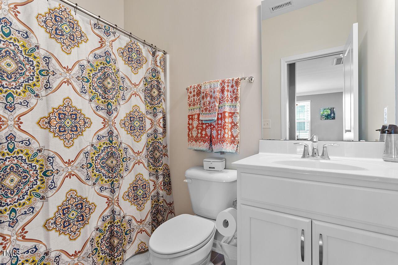 1420 Southpoint Trail Durham, NC 27713 - Photo 17 of 33 a bathroom with a toilet sink and mirror