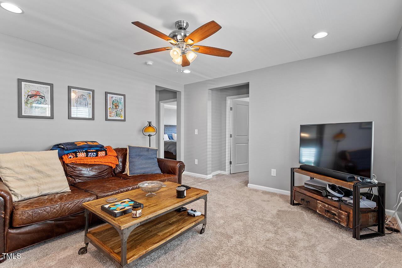 1420 Southpoint Trail Durham, NC 27713 - Photo 18 of 33 a living room with furniture and a flat screen tv