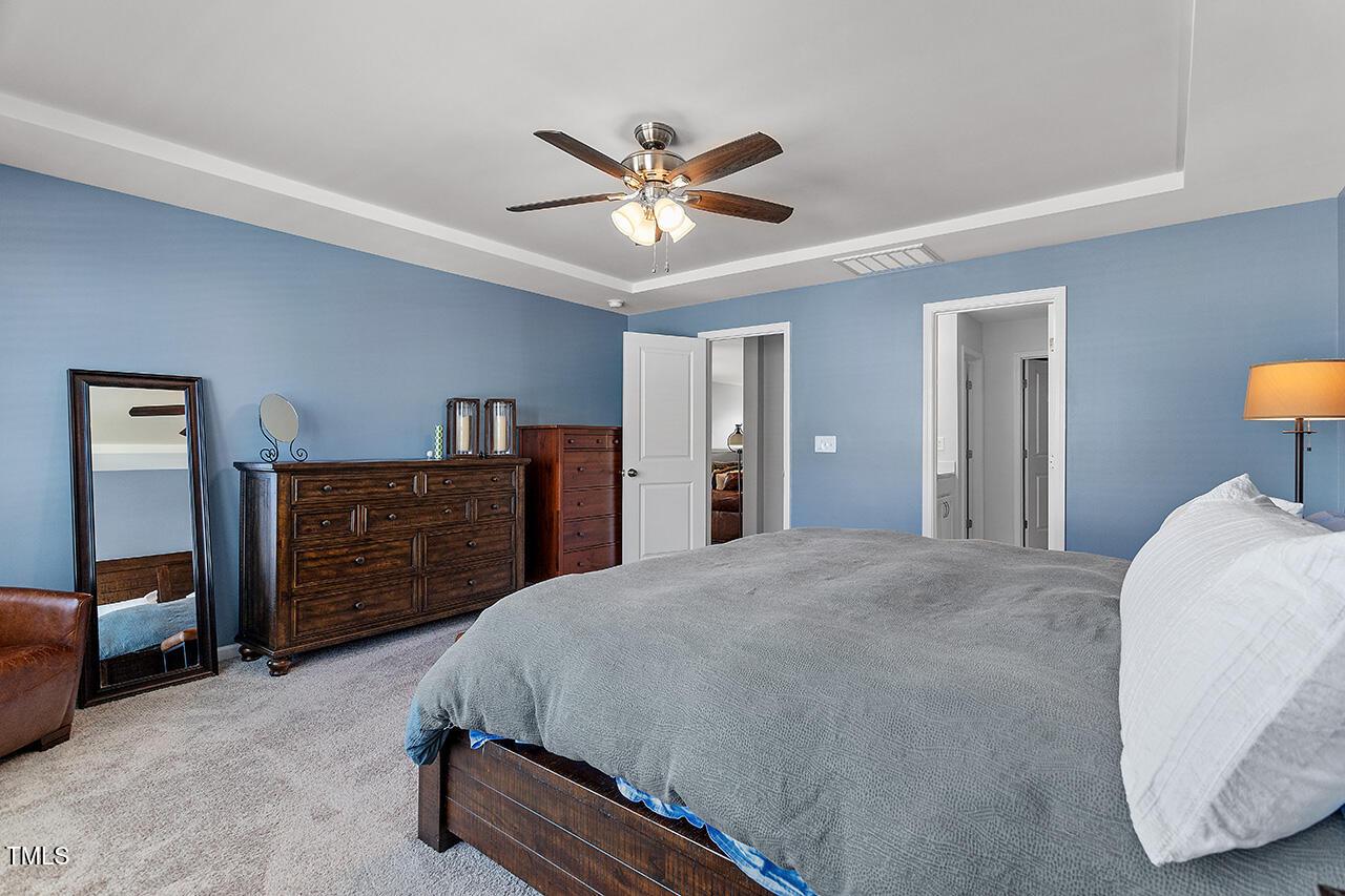1420 Southpoint Trail Durham, NC 27713 - Photo 24 of 33 a bedroom with a bed and a chandelier