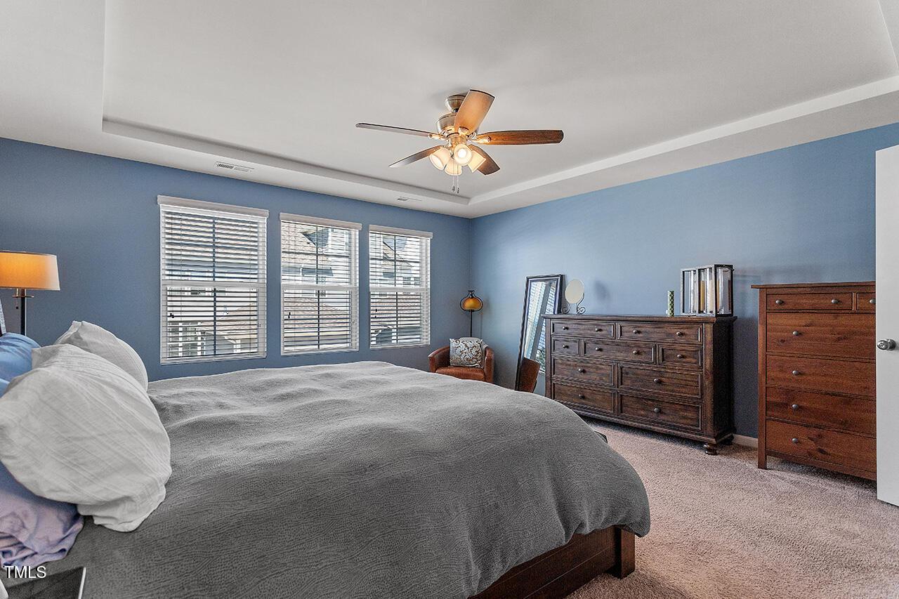 1420 Southpoint Trail Durham, NC 27713 - Photo 25 of 33 a spacious bedroom with a bed a dresser and a chandelier