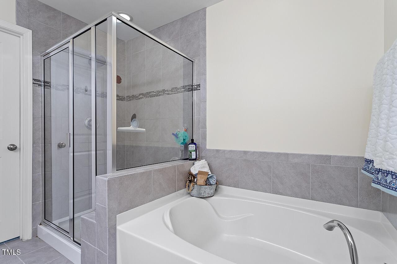 1420 Southpoint Trail Durham, NC 27713 - Photo 26 of 33 a bathroom with a tub and shower