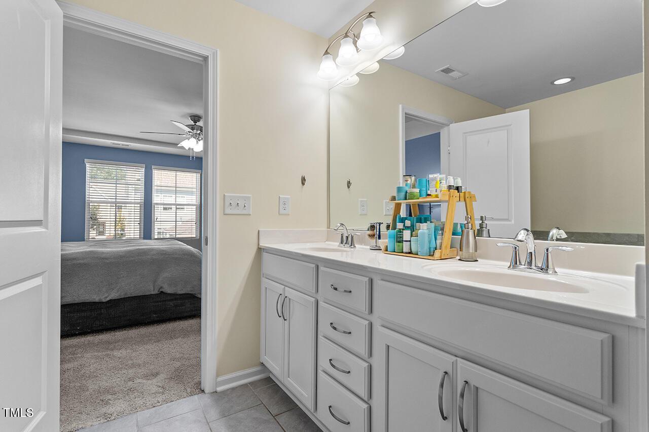1420 Southpoint Trail Durham, NC 27713 - Photo 27 of 33 a en suite bathroom with 2 sink flowerpot and a mirror
