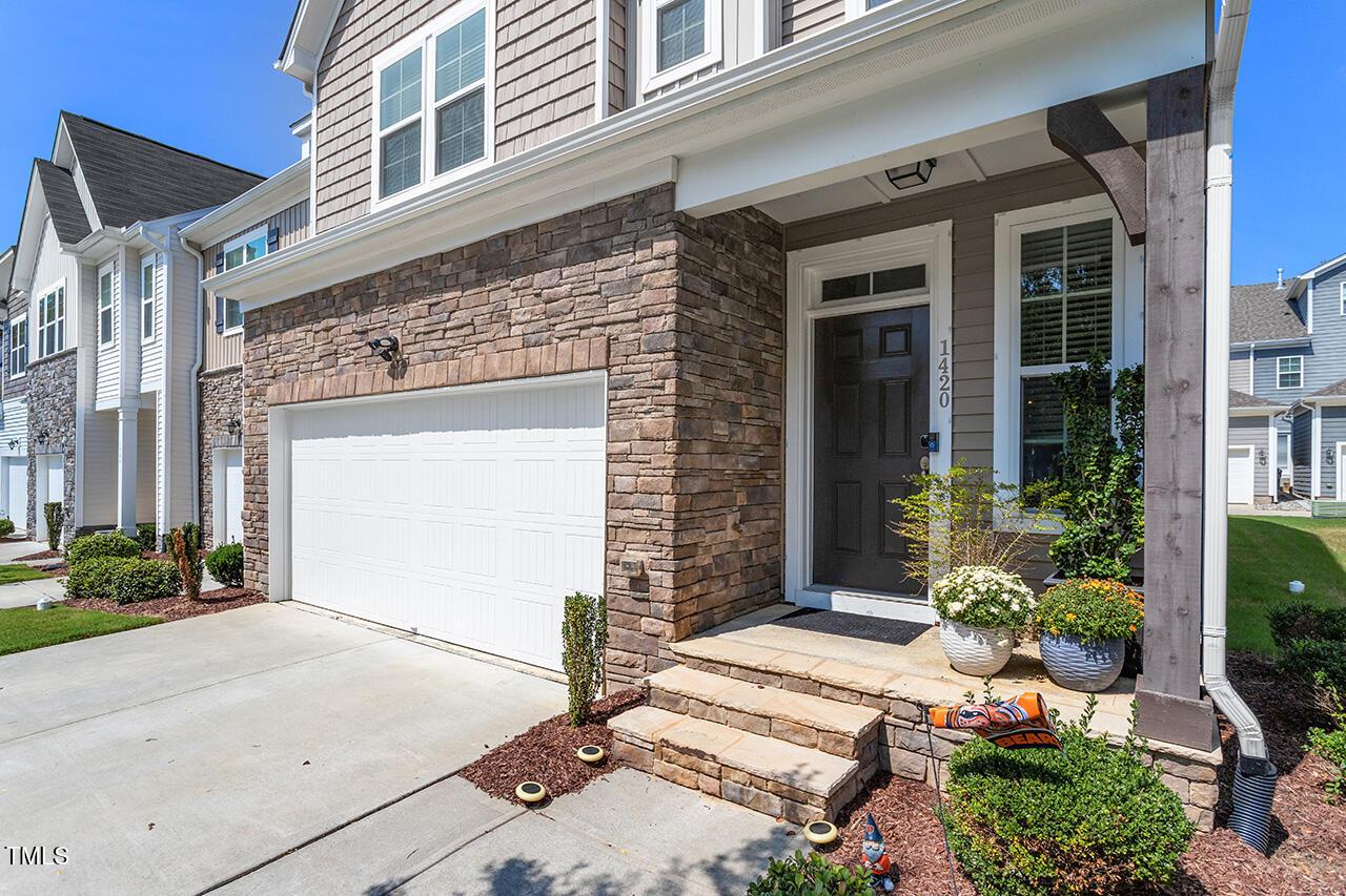 1420 Southpoint Trail Durham, NC 27713 - Photo 3 of 33 a view of a house with potted plants and a garage