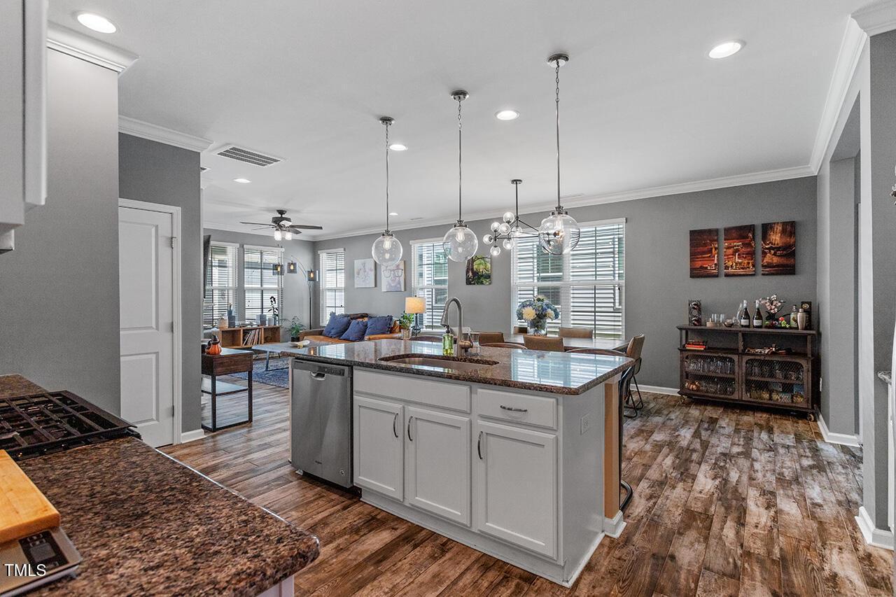 1420 Southpoint Trail Durham, NC 27713 - Photo 9 of 33 a kitchen with stainless steel appliances granite countertop a sink stove and refrigerator