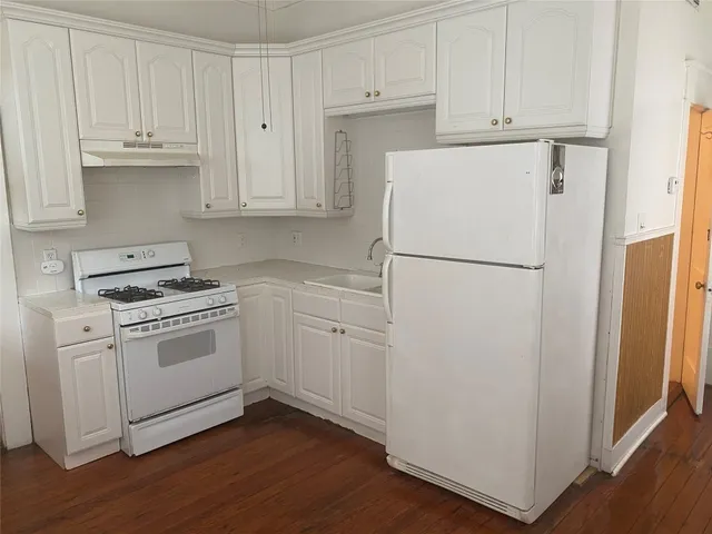 a white refrigerator freezer sitting inside of a kitchen