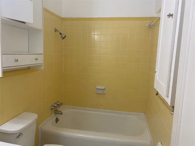 a bathroom with a bathtub and shower