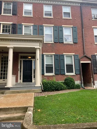 a view of a brick building with a yard